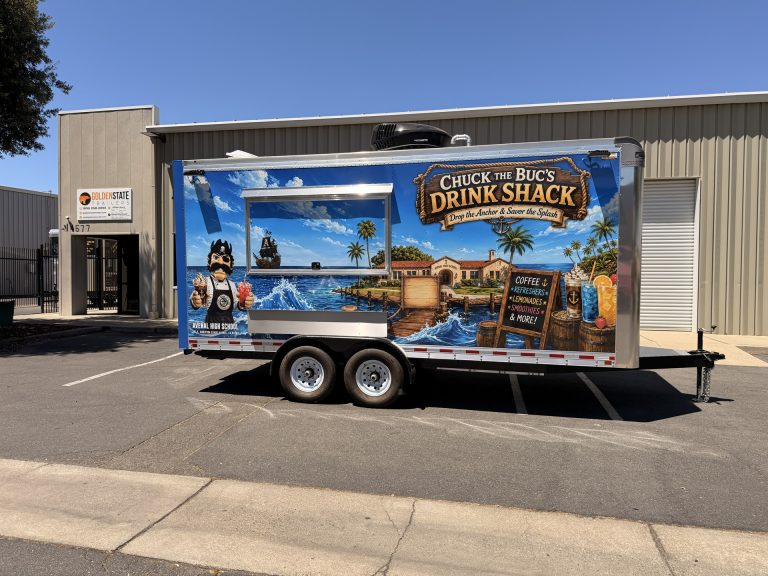 Side profile of the Avenal High School food trailer with large service window and tandem axles