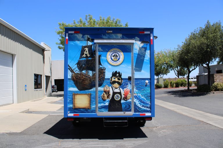 Rear exterior of the Avenal High School school food trailer with branded access door